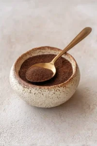 Ryze Mushroom Coffee powder in rustic bowl with gold spoon